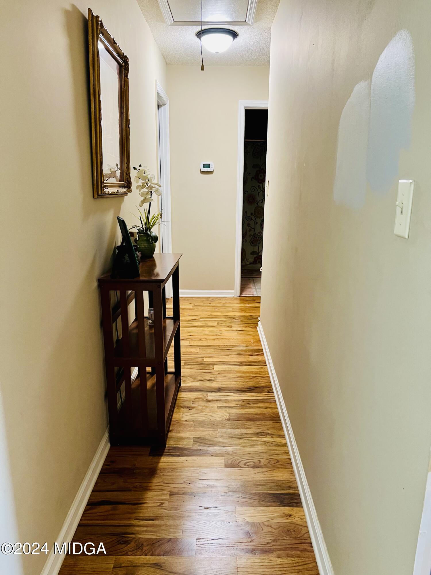 25 Ruby Road Jackson, GA 30233 - Photo 24 of 29 a view of a hallway with wooden floor and staircase