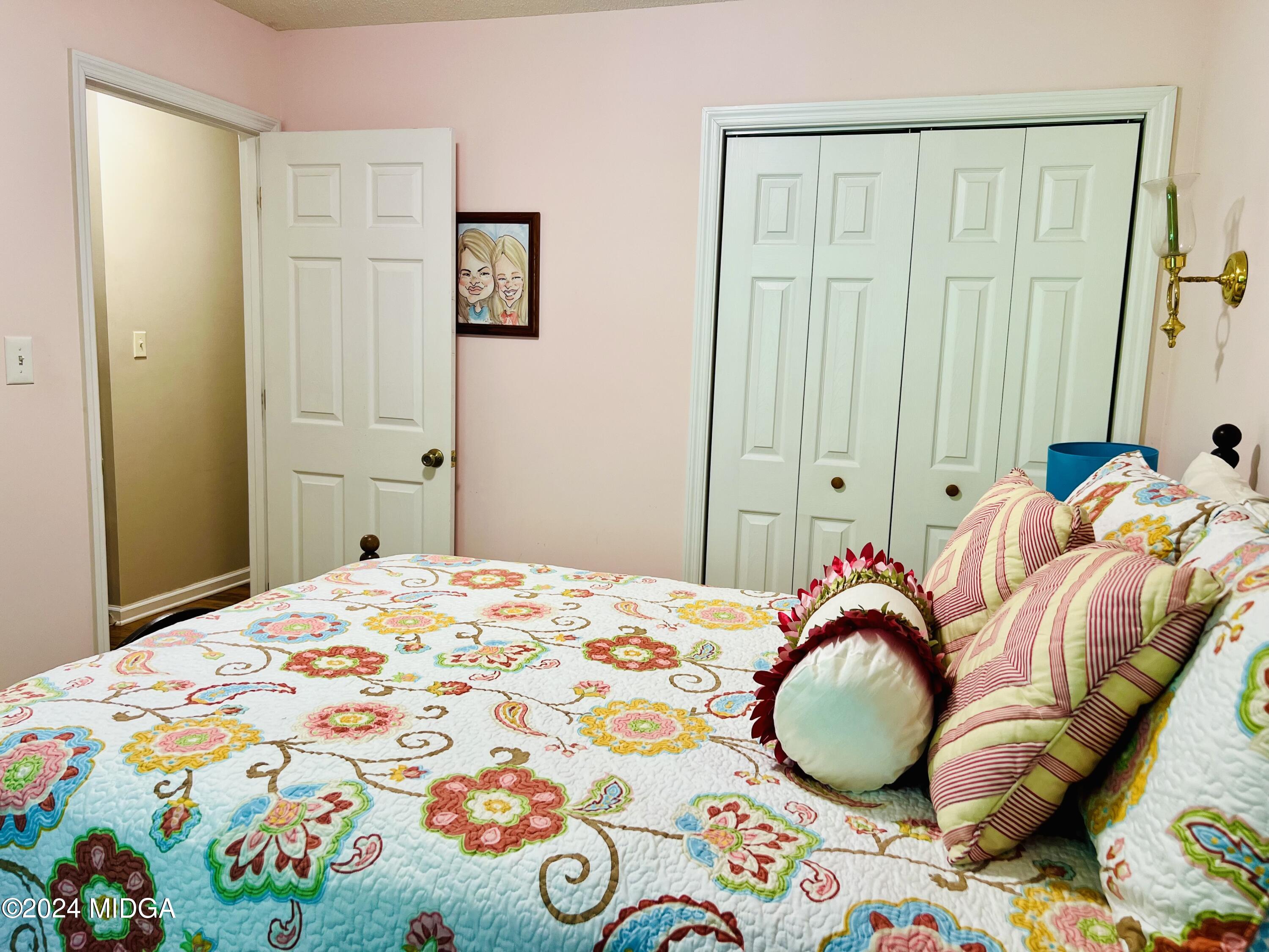 25 Ruby Road Jackson, GA 30233 - Photo 27 of 29 a bedroom with a bed and painting on the wall