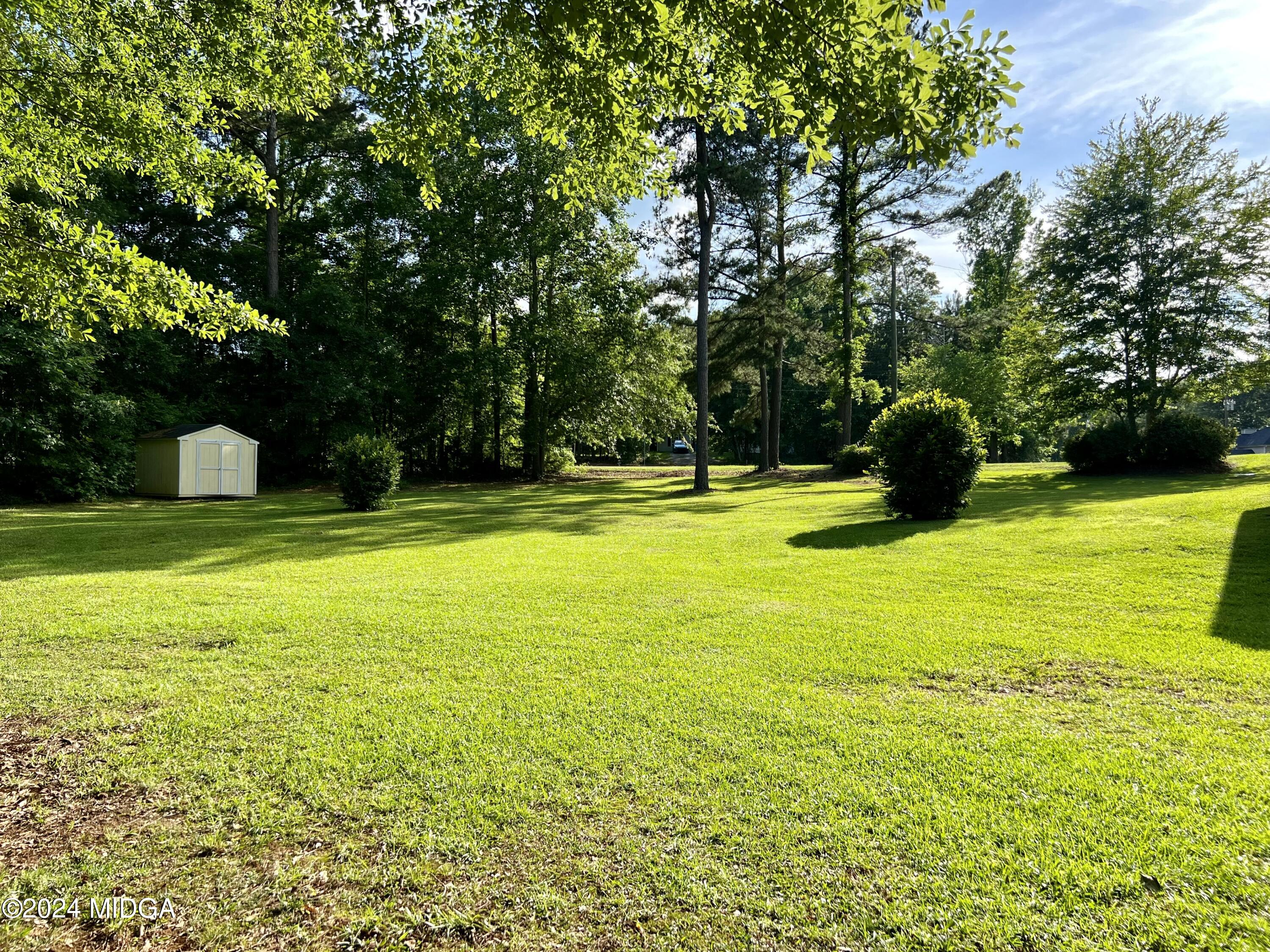 25 Ruby Road Jackson, GA 30233 - Photo 8 of 29 a view of a swimming pool with a garden and trees