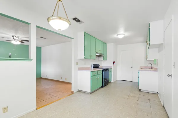 a kitchen with cabinets and a stove