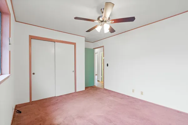 a view of a room with a ceiling fan