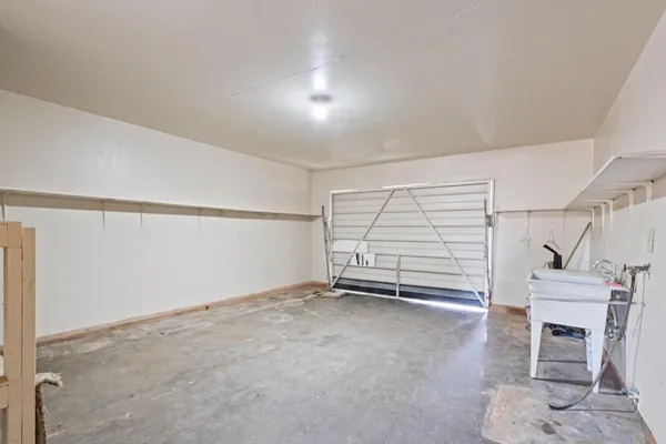 an empty room with a fireplace and fan
