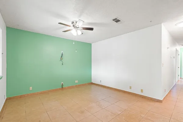 a view of a room with a ceiling fan and a fan