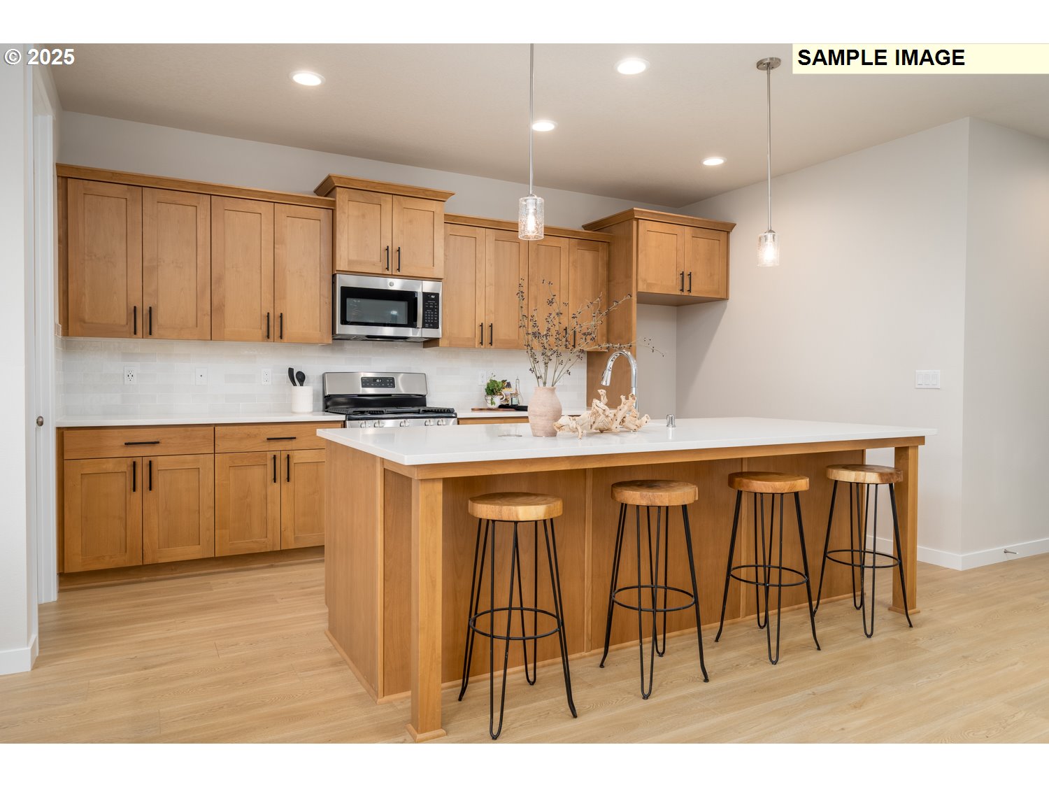 9219 South 3rd Street, Unit 111 Ridgefield, WA 98642 - Photo 8 of 23 a kitchen with stainless steel appliances granite countertop a stove a sink a refrigerator and a microwave