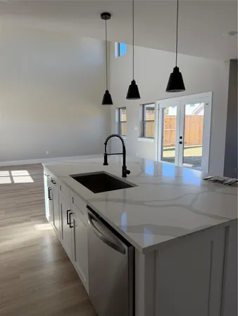 a kitchen with a sink a counter top space and cabinets