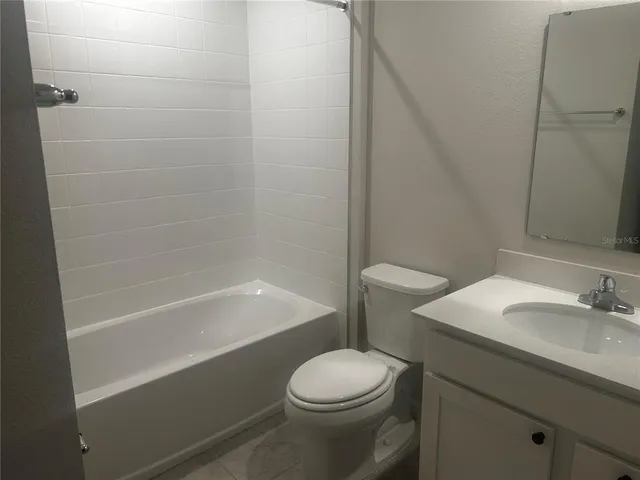 a bathroom with a sink a toilet and bathtub