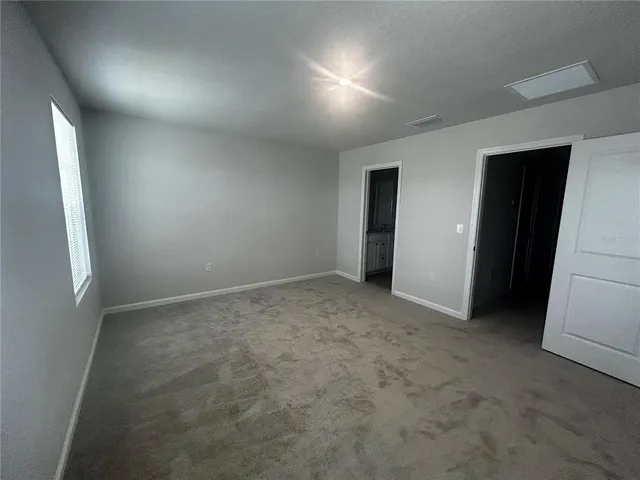 an empty room with windows and entrance