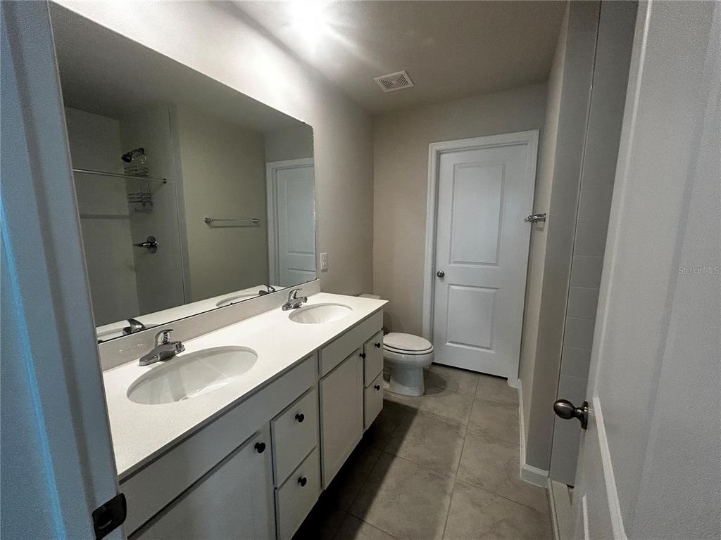 14124 Crimson Avenue Bradenton, FL 34211 - Photo 17 of 27 a bathroom with a double vanity sink toilet and shower