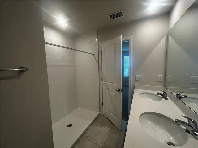 a bathroom with a sink and shower