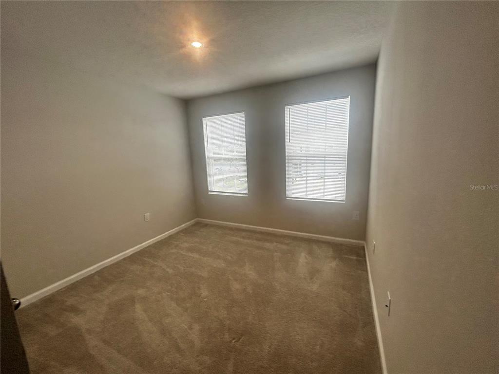 14124 Crimson Avenue Bradenton, FL 34211 - Photo 8 of 27 an empty room with windows