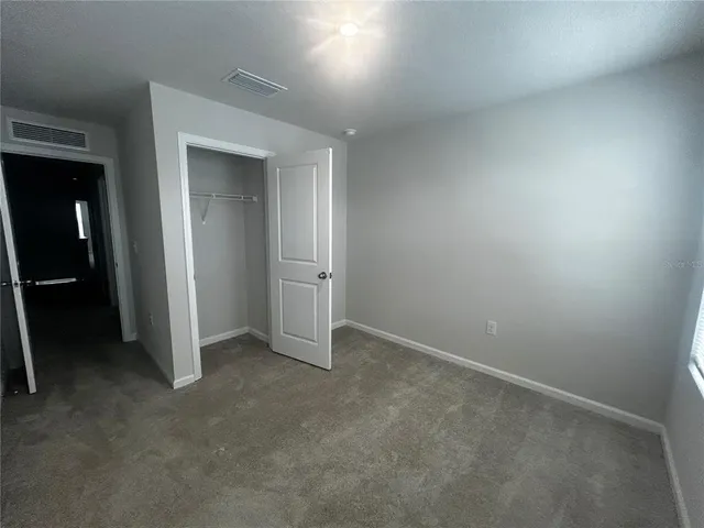 an empty room with closet area