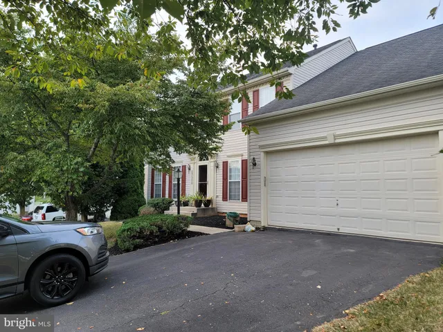 a view of a car parked in front of a house