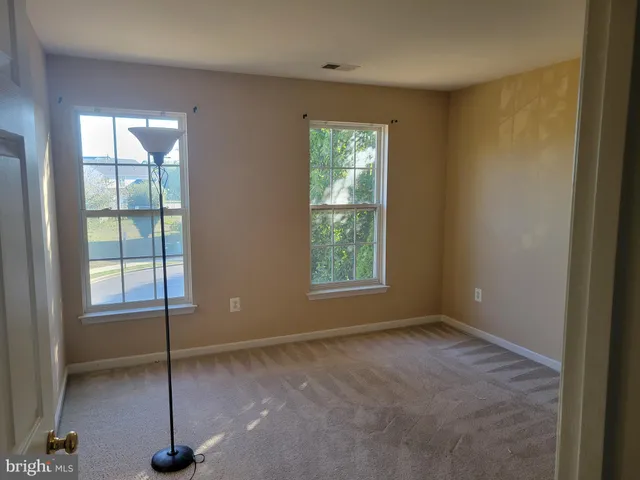 a view of an empty room with windows
