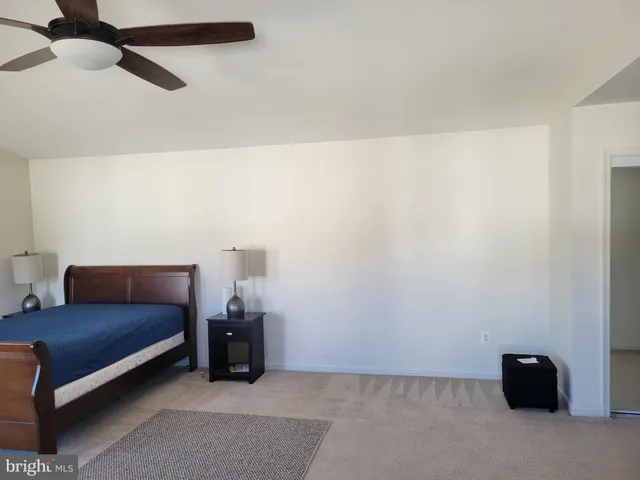 a living room with furniture and a ceiling fan