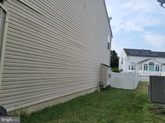 a view of house with backyard and garden