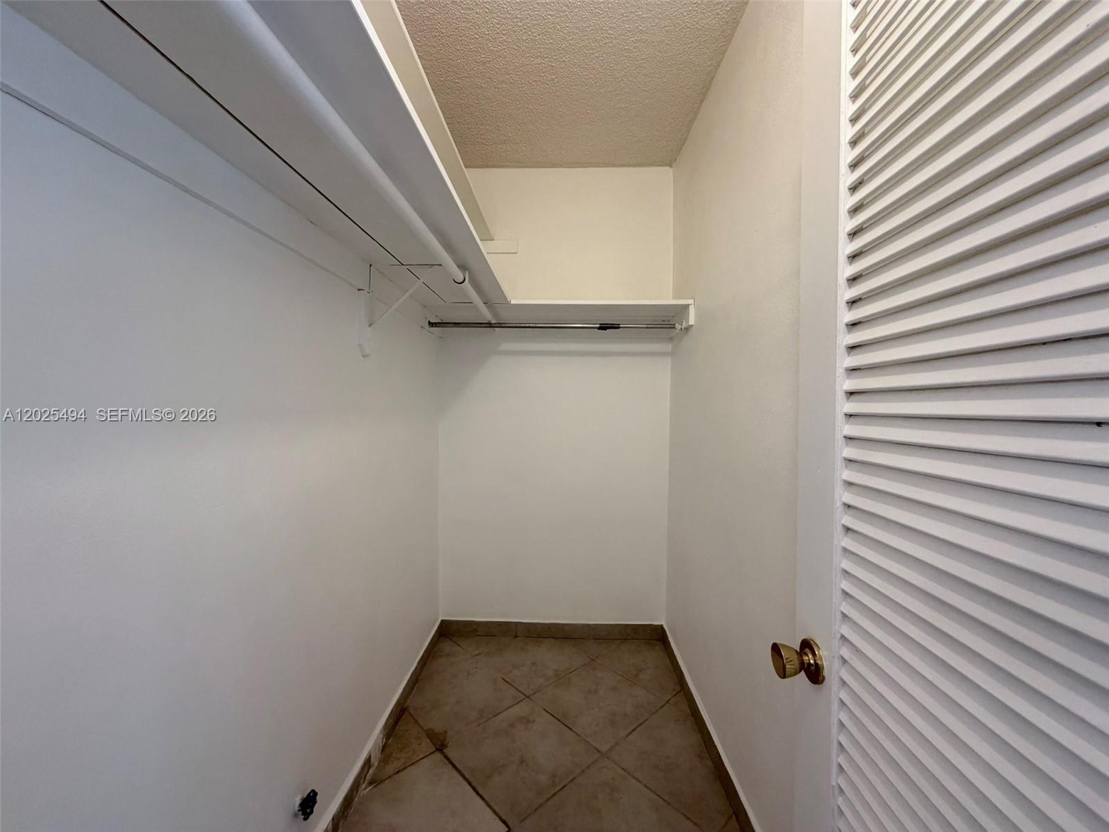 9159 Southwest 77th Avenue, Unit 112 Miami, FL 33156 - Photo 32 of 38 a view of a room with rack on the wall