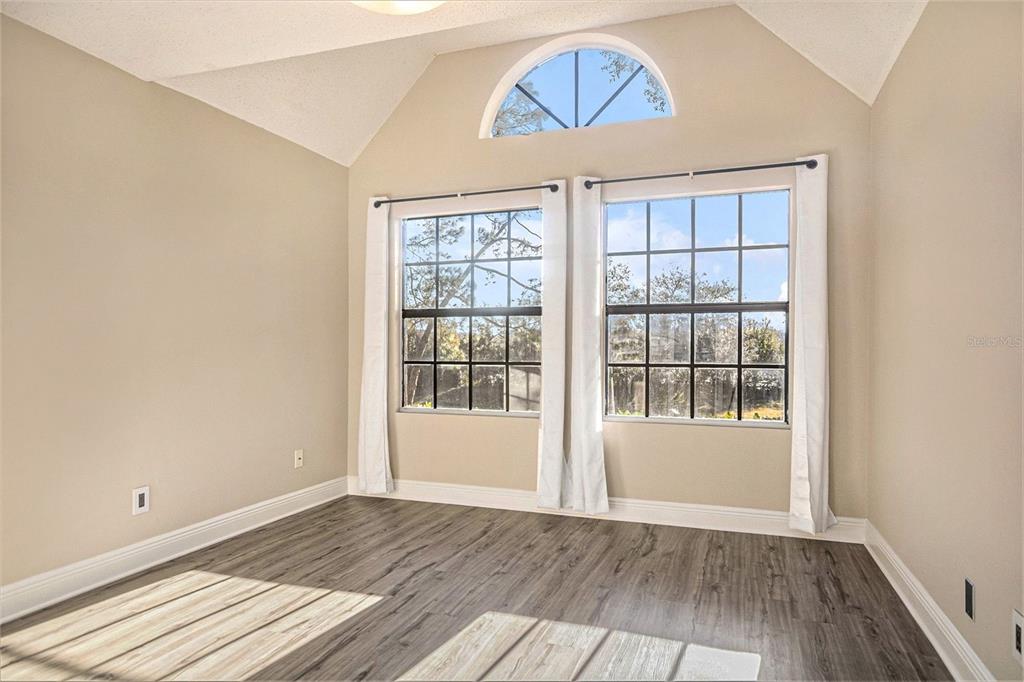 315 Lakepointe Drive, Unit 104 Altamonte Springs, FL 32701 - Photo 9 of 20 an empty room with wooden floor and windows