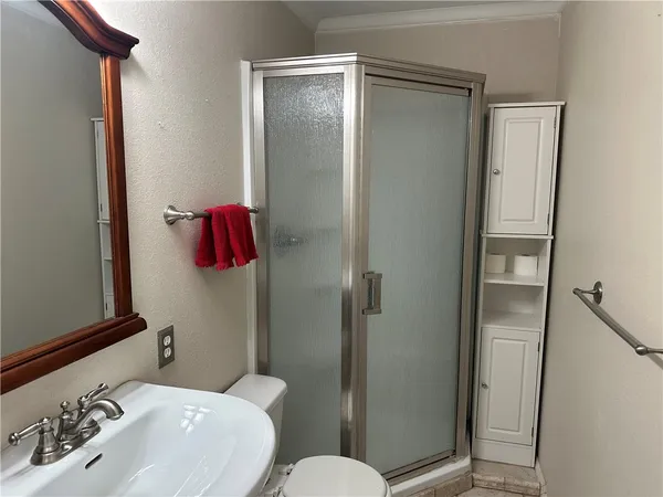 a bathroom with a sink toilet and shower