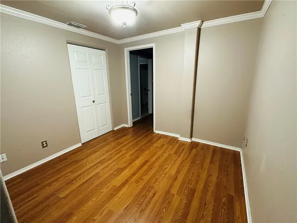 a view of room with wooden floor