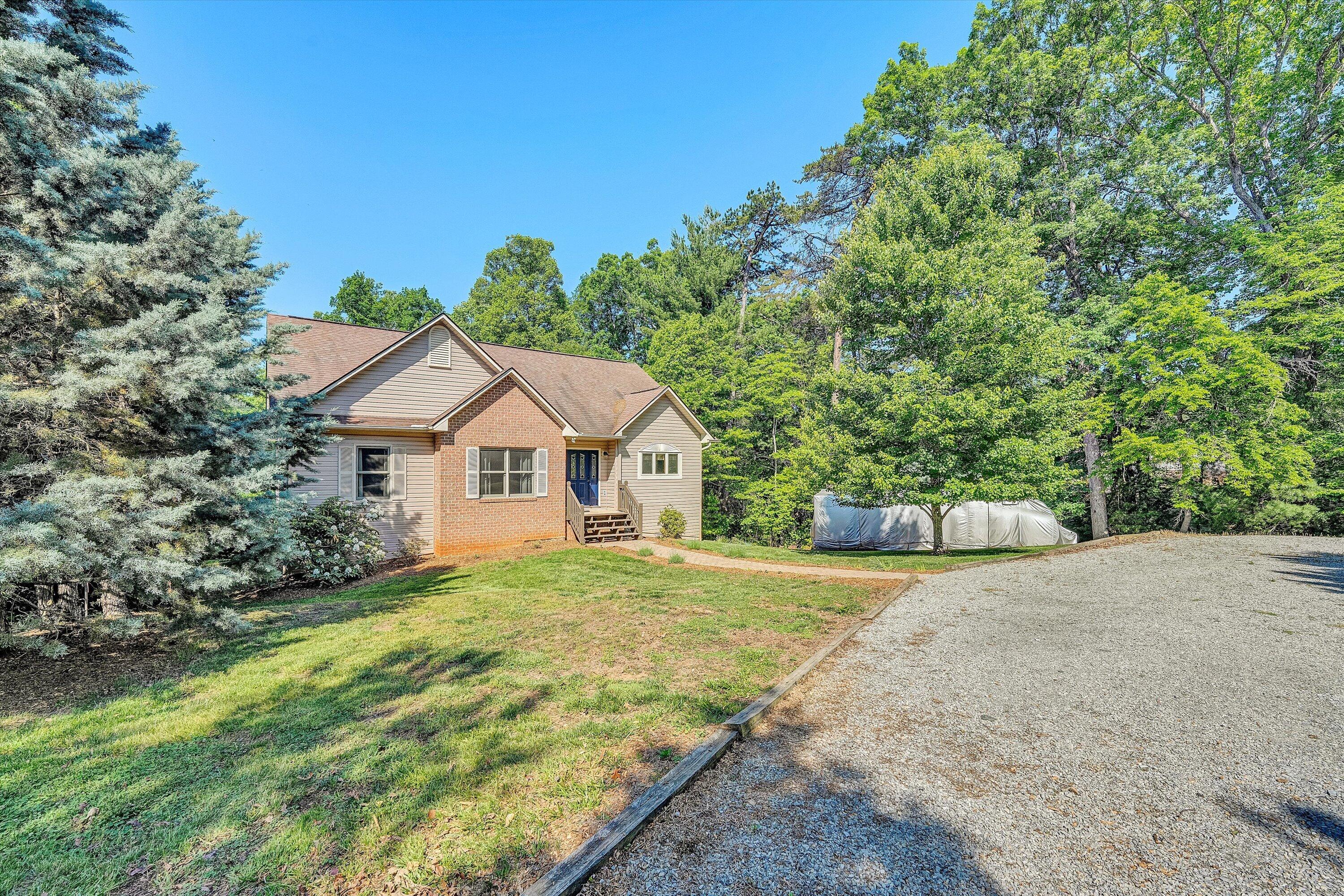 400 Harbor Moneta, VA 24121 - Photo 2 of 51 a front view of a house with a yard and trees