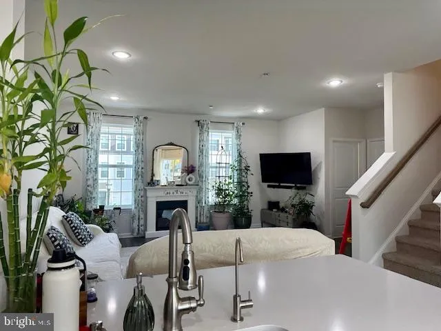 a kitchen with a sink stainless steel appliances and white cabinets