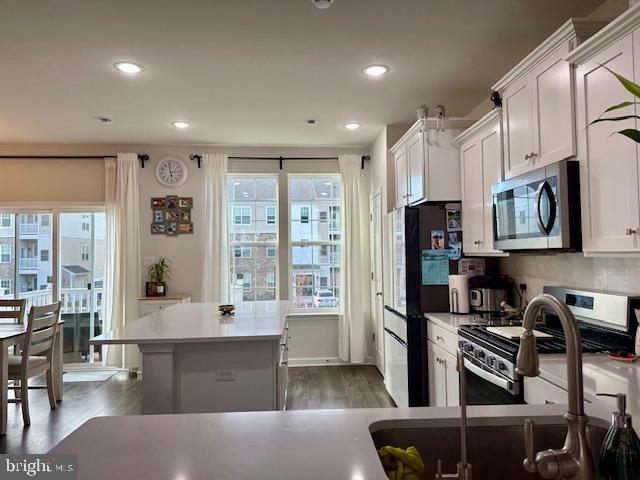 35 Stanton Road Mount Holly, NJ 08060 - Photo 25 of 49 a large kitchen with stainless steel appliances granite countertop a refrigerator a stove a sink dishwasher and white cabinets with wooden floor