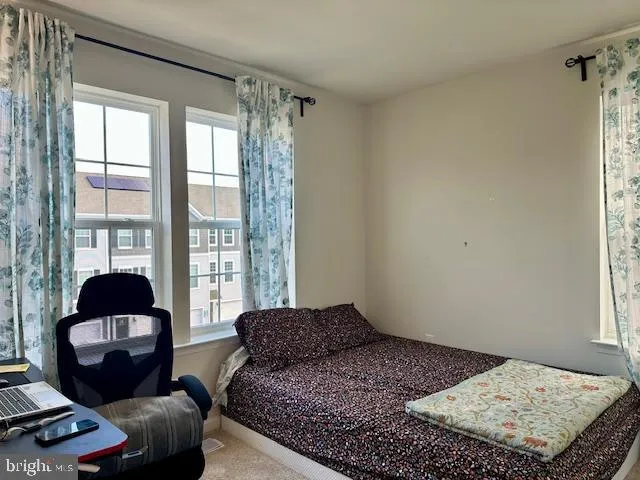 a children room with toys a ceiling fan and a window