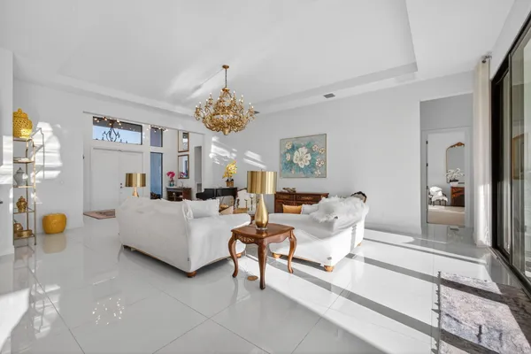 a kitchen with stainless steel appliances kitchen island granite countertop a table chairs and a view of living room