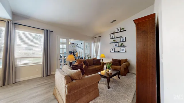 a living room with furniture a window and a flat screen tv