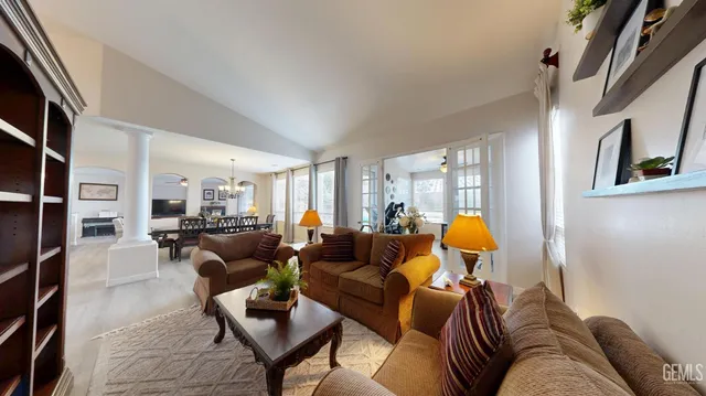 a living room with furniture and a lamp