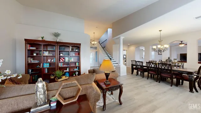 a living room with furniture a dining table and a bookshelf