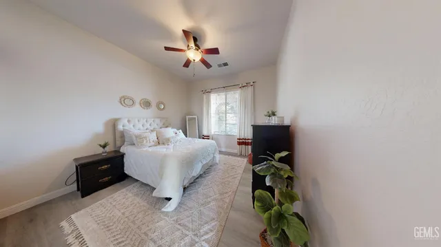 a living room with furniture a chandelier and a rug