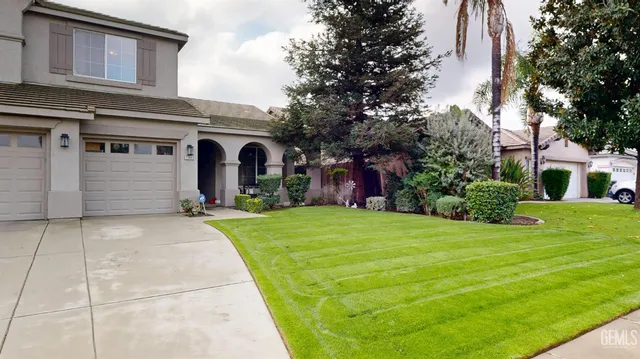 a front view of house with yard and trees