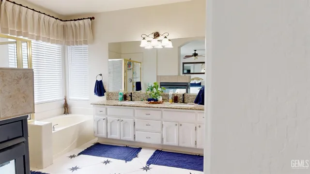 a kitchen with a white cabinets and chandelier