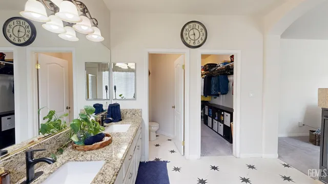 a living room with furniture a clock and a view of bathroom