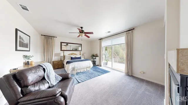 a bedroom with furniture and a large window