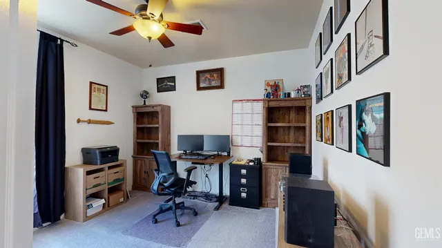 a view of a workspace with furniture and a workspace