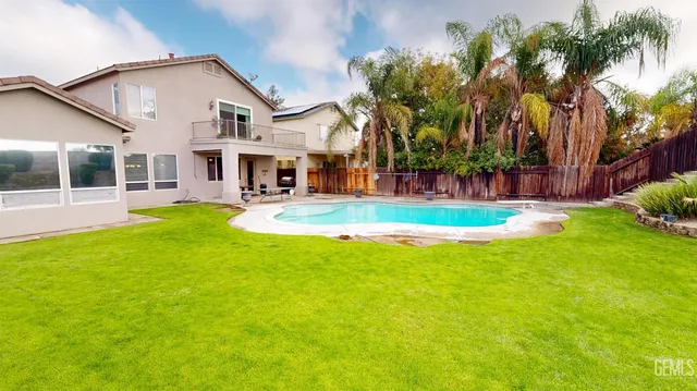 a view of a house with swimming pool and sitting area