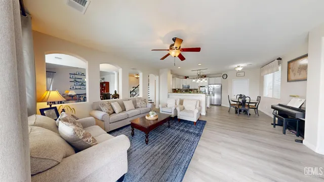 a living room with furniture and kitchen view