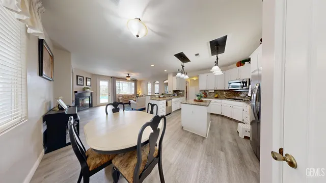 a kitchen with a table chairs and refrigerator