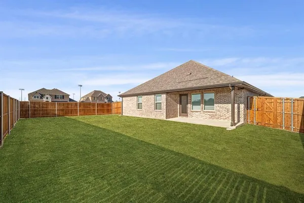 a view of an house with backyard space and balcony
