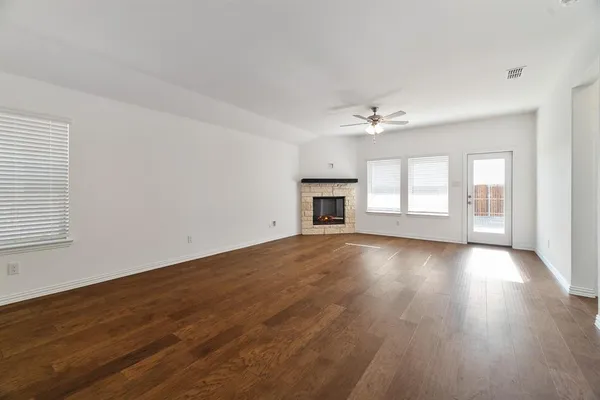 a view of a hallway to rooms and stairs