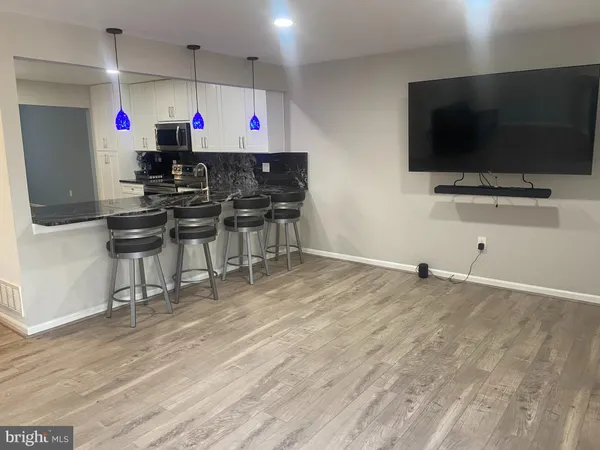a view of a room with furniture and flat screen tv