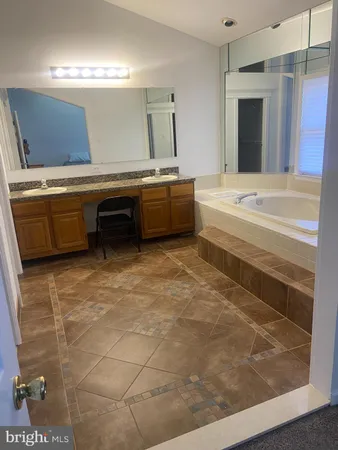 a en suite bathroom with a sink and a mirror