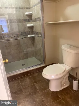 a bathroom with a toilet and a shower