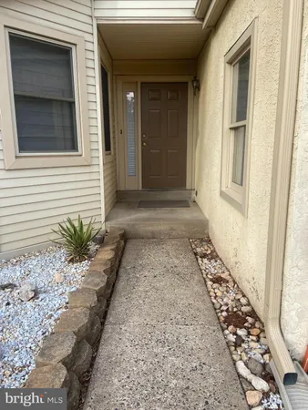 a view of a pathway of a house with a porch