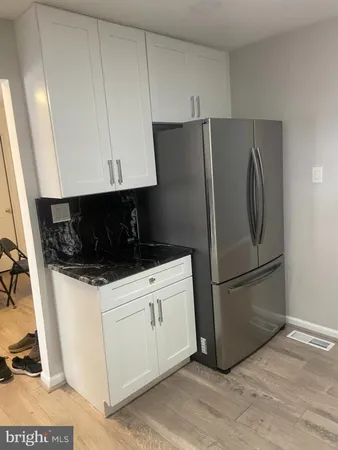 a kitchen with a refrigerator sink and cabinets