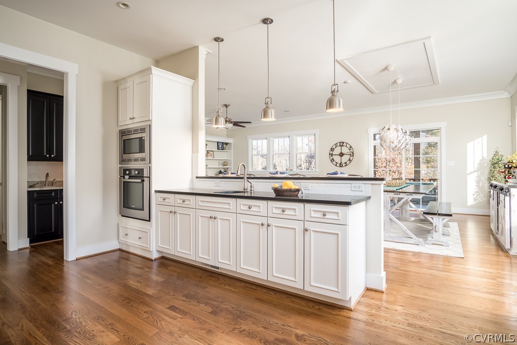 16006 Alsdell Road Midlothian, VA 23112 - Photo 11 of 46 a kitchen with stainless steel appliances granite countertop a sink a stove and a wooden floors