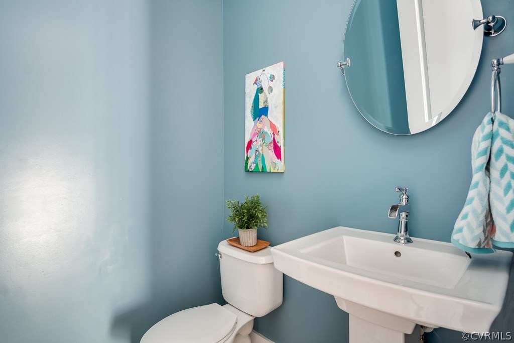 16006 Alsdell Road Midlothian, VA 23112 - Photo 23 of 46 a bathroom with a sink and mirror with toilet