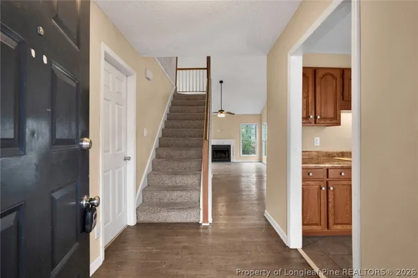 a view of a hallway with wooden floor and entryway
